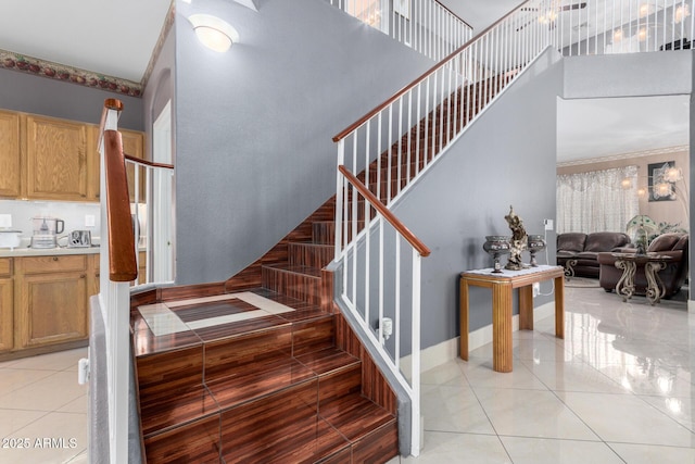 stairway featuring tile patterned floors and a high ceiling