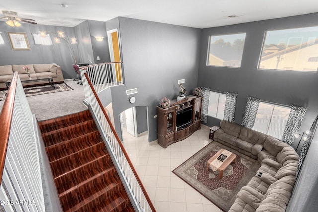 tiled living room featuring ceiling fan