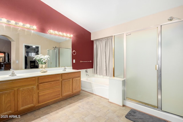 bathroom with shower with separate bathtub, lofted ceiling, and vanity