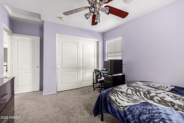 carpeted bedroom with ceiling fan and a closet