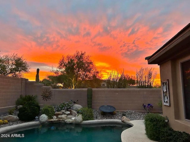 view of pool at dusk