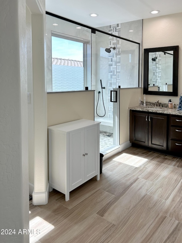 bathroom with an enclosed shower and vanity