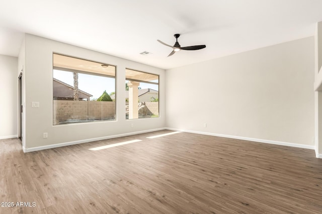 spare room with ceiling fan and hardwood / wood-style flooring