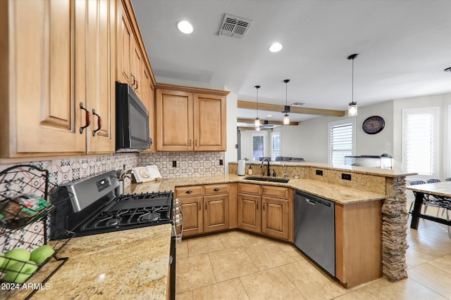 kitchen with hanging light fixtures, sink, kitchen peninsula, black appliances, and light stone countertops