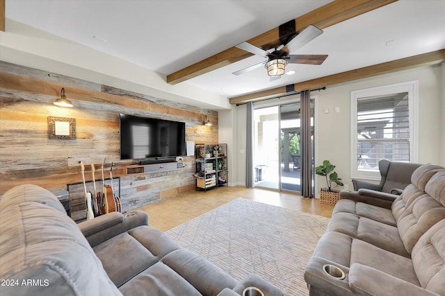 living room with beam ceiling, light tile patterned floors, and ceiling fan