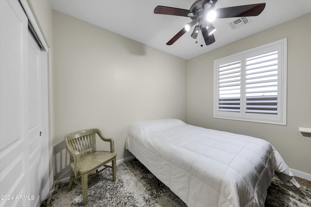 bedroom featuring ceiling fan, a closet, and carpet flooring