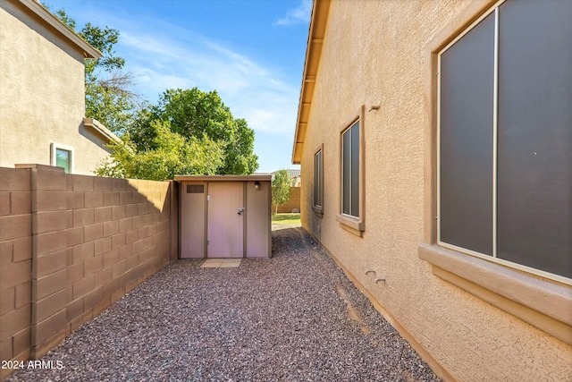 view of property exterior featuring a storage unit