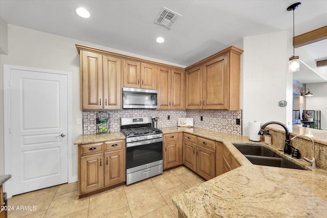 kitchen with beamed ceiling, hanging light fixtures, sink, appliances with stainless steel finishes, and decorative backsplash