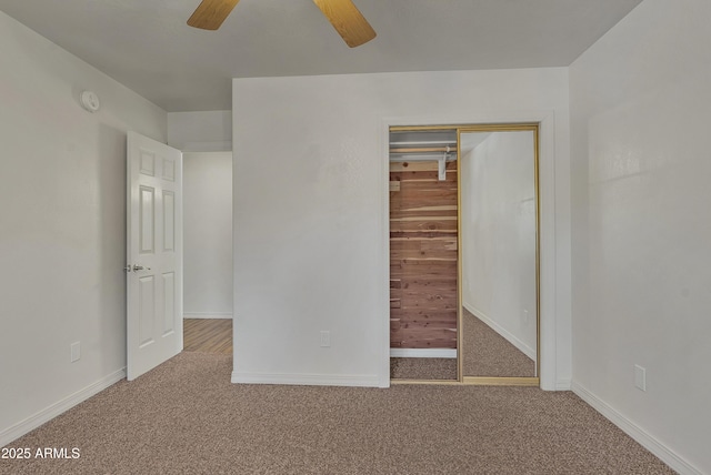 unfurnished bedroom featuring a closet, carpet flooring, and baseboards