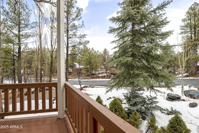 view of snow covered back of property