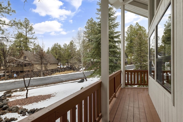 view of snow covered back of property