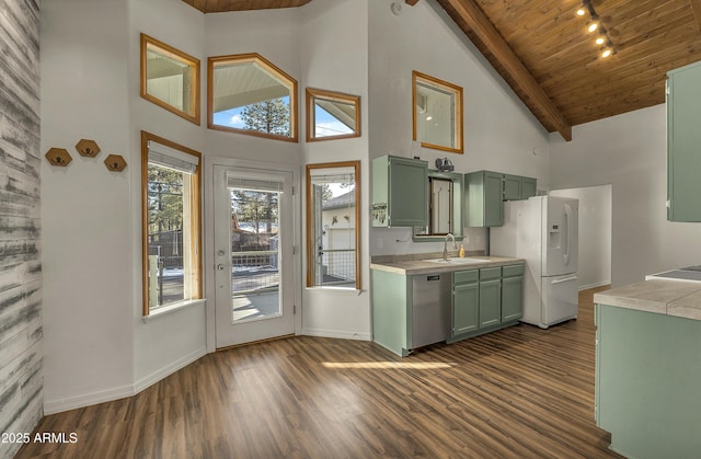 kitchen featuring green cabinetry, stainless steel dishwasher, white fridge with ice dispenser, and light countertops