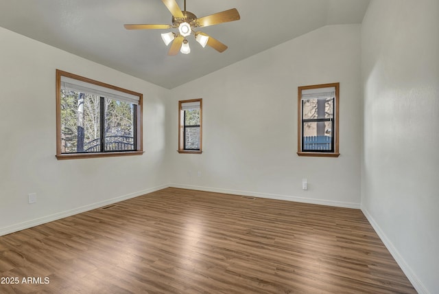 unfurnished room featuring lofted ceiling, wood finished floors, and a ceiling fan