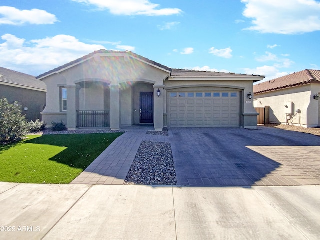 view of front of home with decorative driveway, stucco siding, covered porch, an attached garage, and a front lawn