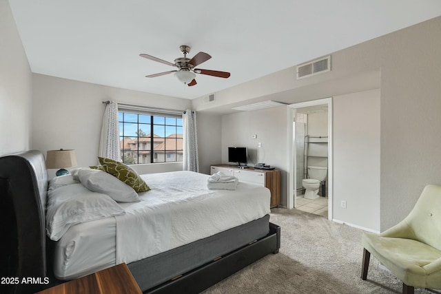 carpeted bedroom featuring ensuite bath and ceiling fan