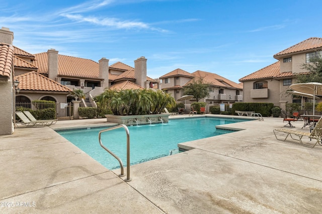 view of swimming pool featuring pool water feature and a patio area