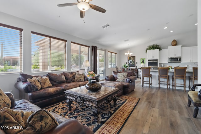 19023 E Buckskin Ct, Rio Verde, AZ 85263 - living area featuring visible vents, wood finished floors, recessed lighting, ceiling fan with notable chandelier, and vaulted ceiling