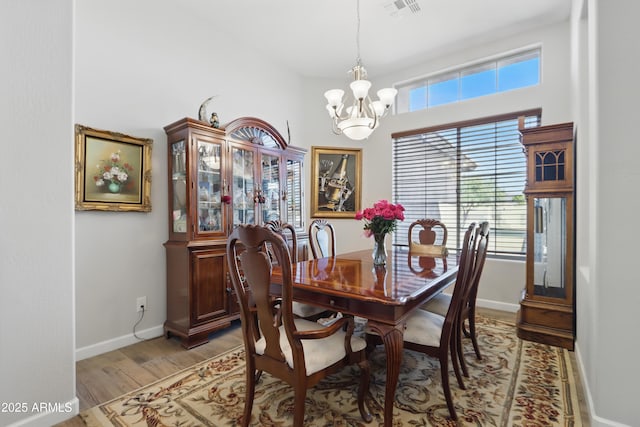 19023 E Buckskin Ct, Rio Verde, AZ 85263 - dining room with light wood-style flooring, baseboards, a chandelier, and visible vents