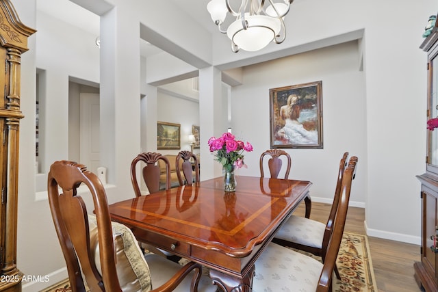19023 E Buckskin Ct, Rio Verde, AZ 85263 - dining room featuring baseboards, wood finished floors, and a chandelier