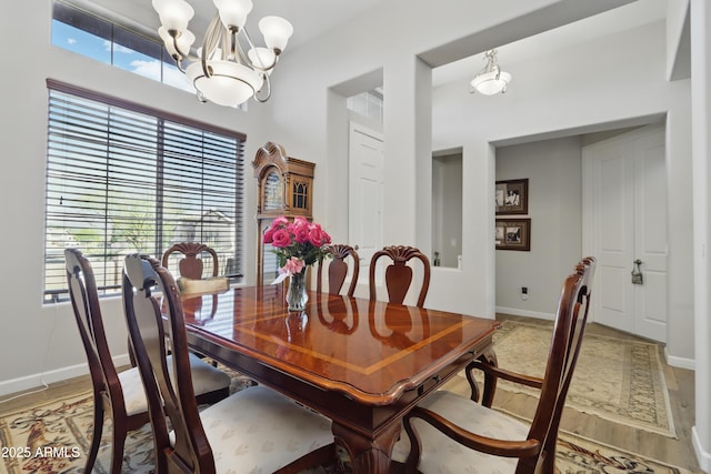 19023 E Buckskin Ct, Rio Verde, AZ 85263 - dining room featuring baseboards, a notable chandelier, and a healthy amount of sunlight