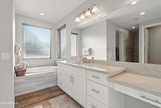 19023 E Buckskin Ct, Rio Verde, AZ 85263 - full bathroom featuring wood finished floors, vanity, recessed lighting, visible vents, and a bath