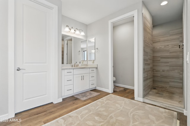 19023 E Buckskin Ct, Rio Verde, AZ 85263 - full bathroom with toilet, tiled shower, vanity, wood finished floors, and baseboards