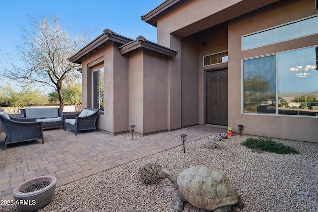 19023 E Buckskin Ct, Rio Verde, AZ 85263 - view of exterior entry with a patio, an outdoor hangout area, and stucco siding
