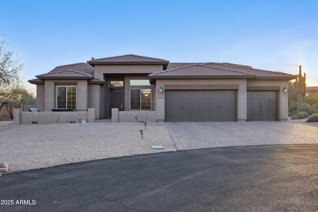 19023 E Buckskin Ct, Rio Verde, AZ 85263 - prairie-style house featuring driveway, stucco siding, a tile roof, and an attached garage
