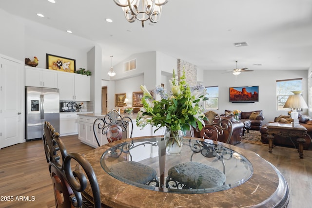 19023 E Buckskin Ct, Rio Verde, AZ 85263 - dining area with wood finished floors, ceiling fan with notable chandelier, vaulted ceiling, and visible vents