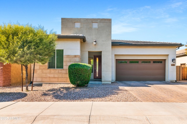 1492 W Bruce Ave, Gilbert, AZ 85233 - view of front facade featuring decorative driveway, an attached garage, stucco siding, and a tiled roof