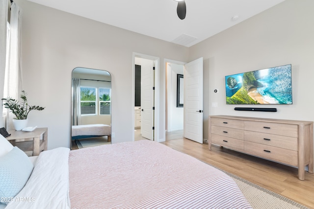 1492 W Bruce Ave, Gilbert, AZ 85233 - bedroom with light wood-style floors, ensuite bath, and ceiling fan