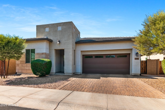 1492 W Bruce Ave, Gilbert, AZ 85233 - view of front of home featuring decorative driveway, an attached garage, stucco siding, and a tiled roof