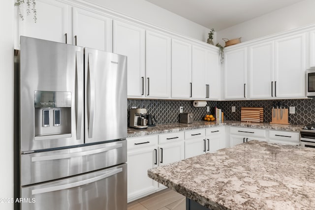 1492 W Bruce Ave, Gilbert, AZ 85233 - kitchen featuring stainless steel refrigerator with ice dispenser, white cabinets, white microwave, light stone countertops, and backsplash