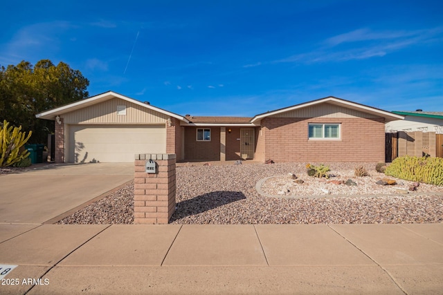 ranch-style home with an attached garage, concrete driveway, and brick siding