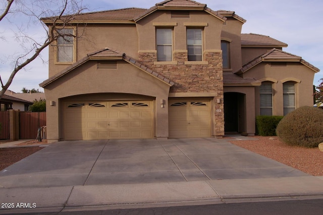 view of front of house with stone siding, a tile roof, fence, and stucco siding