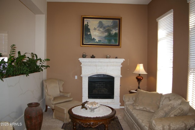 carpeted living room featuring a fireplace