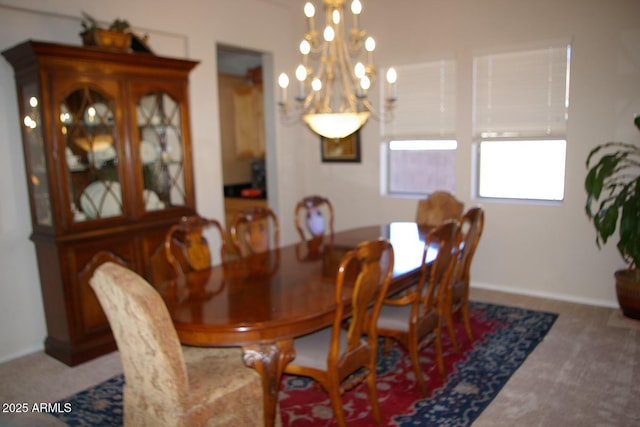 dining area featuring carpet floors and a notable chandelier