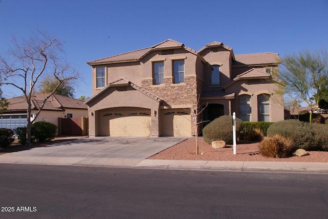 view of front of home featuring stucco siding, fence, a garage, stone siding, and driveway