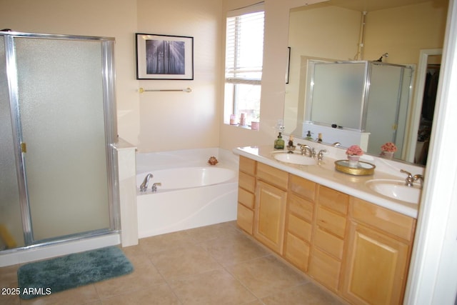 full bathroom featuring a stall shower, tile patterned flooring, and a sink