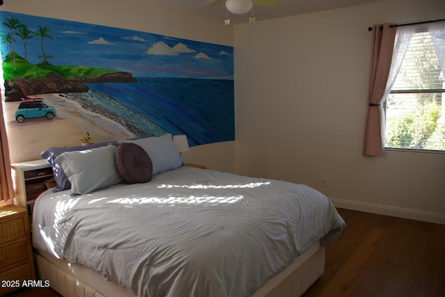 bedroom featuring baseboards and wood finished floors