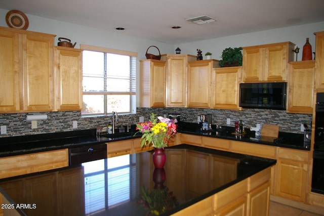 kitchen with dark countertops, black microwave, visible vents, and decorative backsplash