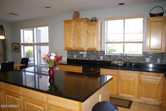 kitchen featuring visible vents, decorative backsplash, light brown cabinets, light tile patterned flooring, and a sink