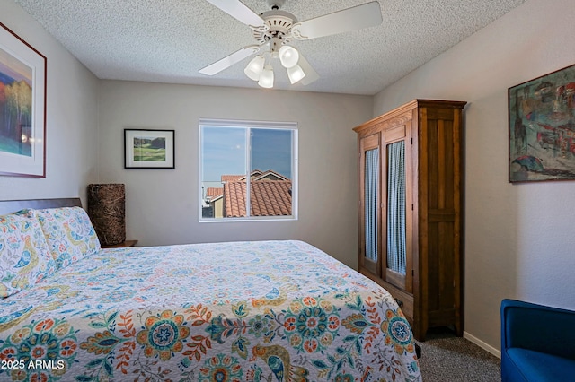 carpeted bedroom with ceiling fan, a textured ceiling, and baseboards