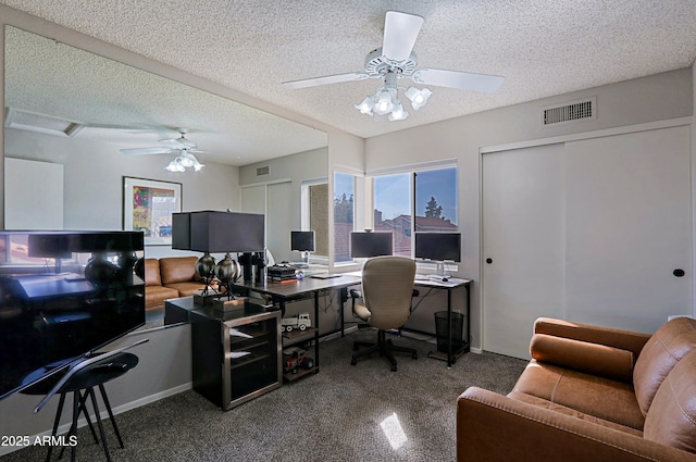 office with a ceiling fan, visible vents, and a textured ceiling