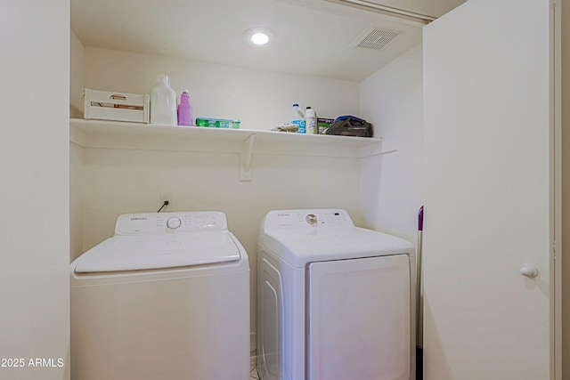 laundry room featuring washer and dryer, laundry area, and visible vents