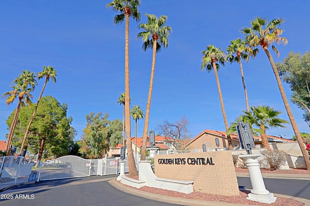 view of street featuring a gate, curbs, and a gated entry