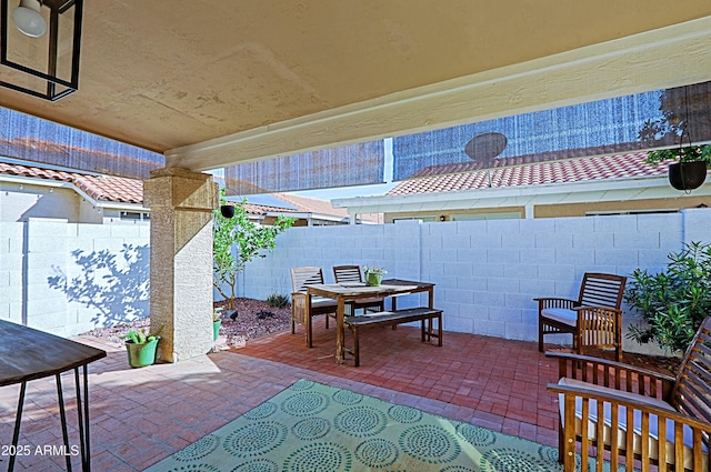 view of patio with outdoor dining space and a fenced backyard