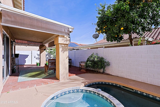 view of pool featuring a fenced backyard, a patio, and an in ground hot tub