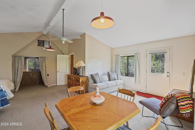 dining room with light carpet, ceiling fan, beamed ceiling, and high vaulted ceiling