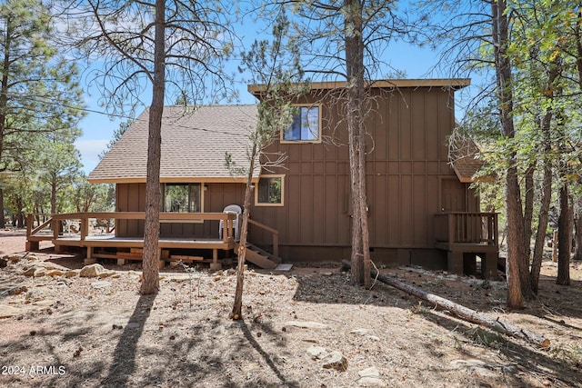 back of house featuring a wooden deck